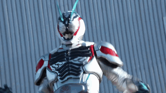 a close up of a person in a superhero costume standing in front of a wall .