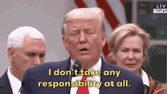 donald trump is speaking into a microphone and saying i don 't take any responsibility at all