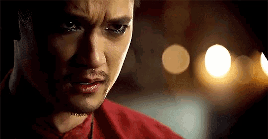 a close up of a man 's face with tears coming down his face .