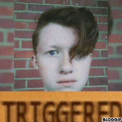 a man 's face is behind a sign that reads triggered