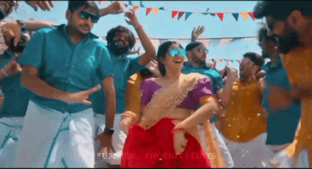 a woman in a red dress is dancing with a group of men