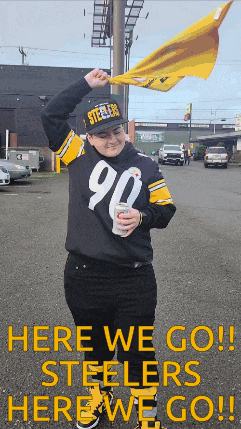 a person wearing a steelers jersey is holding a flag in their hand