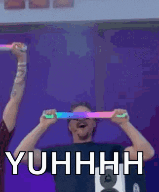 a man is holding glow in the dark sticks in front of his eyes and the words yuhhhh are above him .