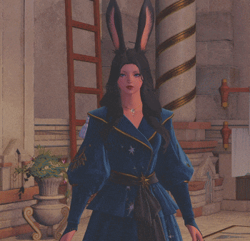 a woman in a blue robe with bunny ears is standing in a room