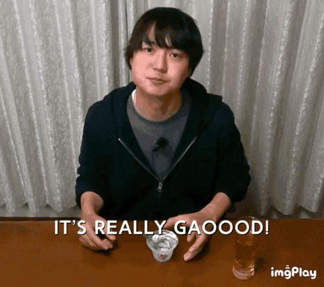 a man sitting at a table with the words it 's really gaoood written below him
