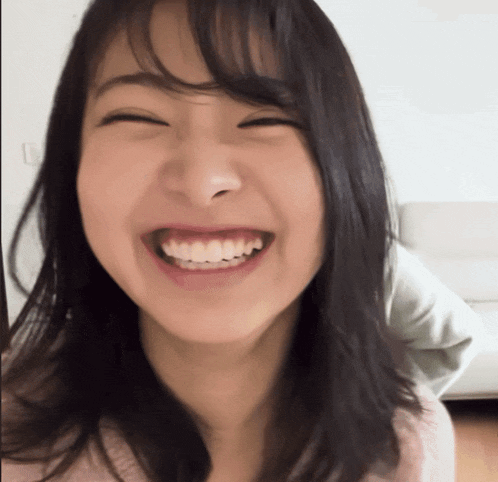 a close up of a woman 's face with a smile on her face