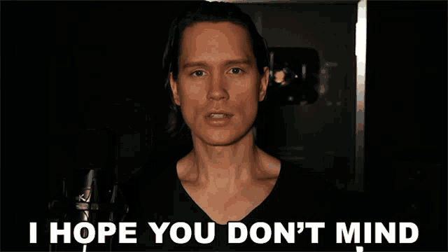 a man says i hope you don 't mind while standing in front of a microphone