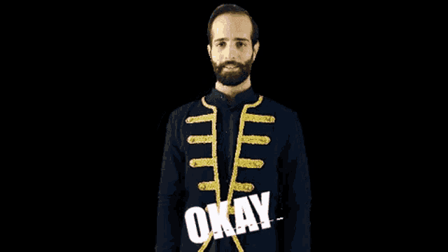 a man with a beard wearing a blue and gold jacket that says okay