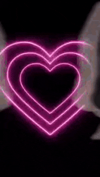 a blurred image of a person 's face with a purple light coming out of their mouth .