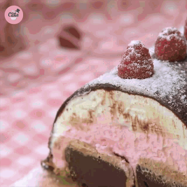 a close up of a cake with raspberries on top
