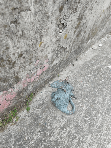 a statue of a dragon is laying on the sidewalk