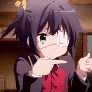 a girl with a bandage on her eye is pointing