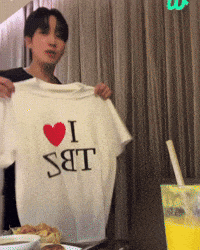 a man is holding up a t-shirt that says i love sbt