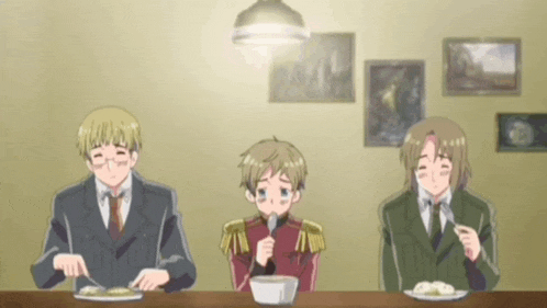 three anime characters are sitting at a table with plates of food