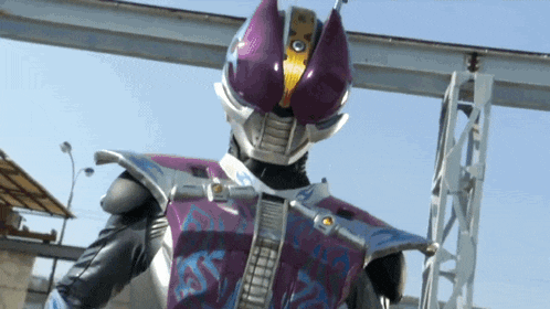 a man in a purple and silver costume with the word sss on the chest