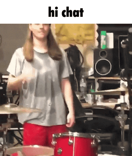 a woman playing a drum set with the words hi chat written above her