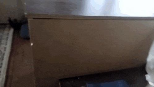 a box is sitting on a wooden floor next to a window