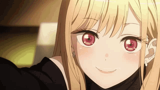 a blonde anime girl with red eyes is smiling for the camera