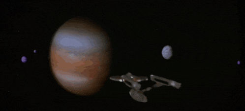 a space ship is flying over a planet in space with a crescent moon in the background .