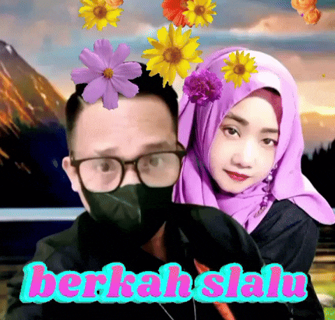 a man wearing glasses and a mask stands next to a woman wearing a purple hijab with flowers on her head