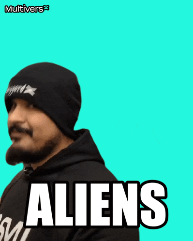 a man with a beard wearing a beanie and a hoodie with the words aliens on it