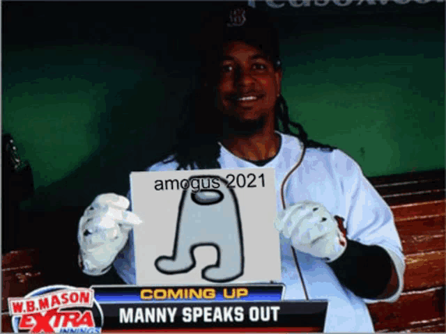 a baseball player holding a sign that says among us 2021