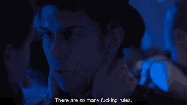 a man and a woman are looking at each other with the words there are so many fucking rules below them