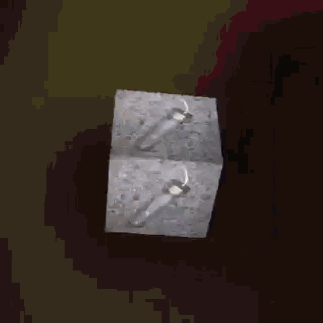 a cube with a hole in the middle is on a table