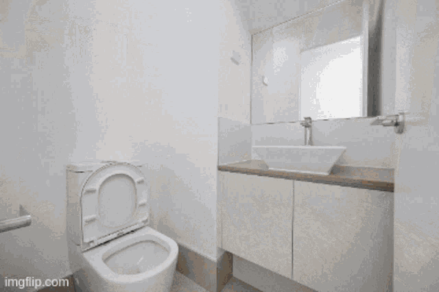 a bathroom with two sinks and a mirror that says imgflip.com at the bottom