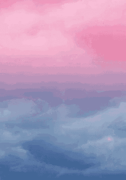 a pink and blue ombre sky with clouds in it