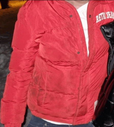 a person wearing a red jacket that says retro team