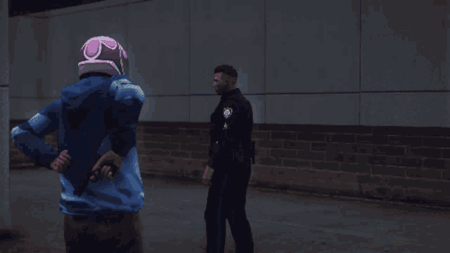 a man wearing a pink helmet stands next to a man wearing a police uniform