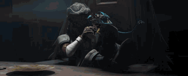 a man in a helmet sits at a table with a plate of food