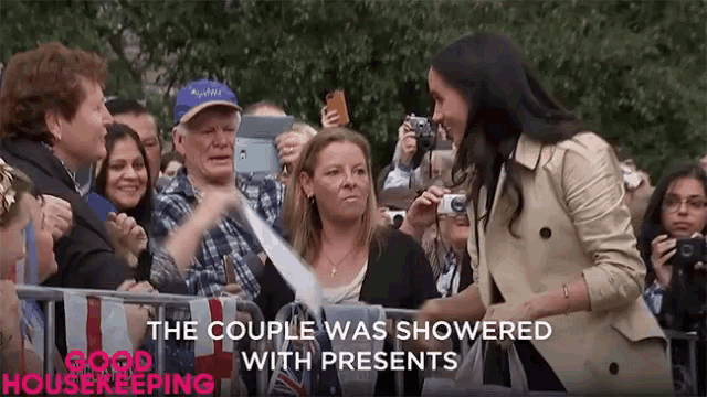 a woman stands in front of a crowd with the words " the couple was showered with presents "
