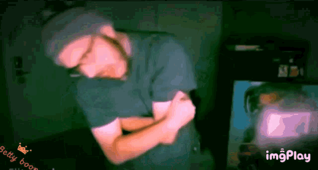 a gif of a man flexing his muscles with the words betty boom in the lower right corner