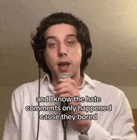 a man wearing headphones is singing into a microphone and says and i know the hate comments only happened