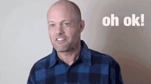 a bald man wearing a blue plaid shirt is making a funny face and saying oh ok .