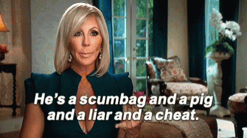 a woman in a blue dress is sitting in a living room talking about a pig and a liar .