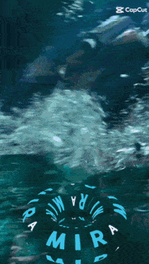 a person is swimming in the ocean with a mira float