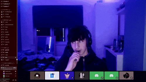 a man wearing headphones is on a video call with several other people