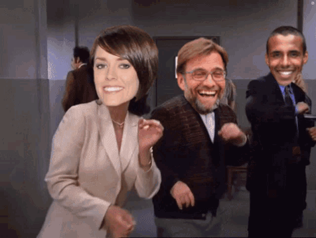 a woman and two men are dancing in a room