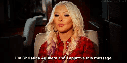 a woman in a red plaid shirt says i 'm christina aguilera and i approve this message ..