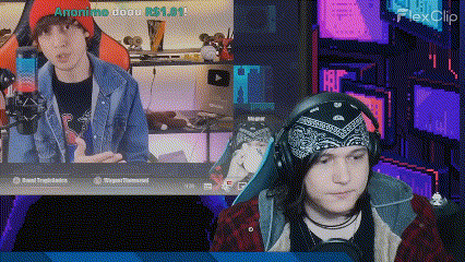 a man wearing a bandana is sitting in front of a computer screen .