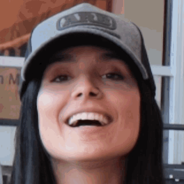 a close up of a woman wearing a hat that says aa on it