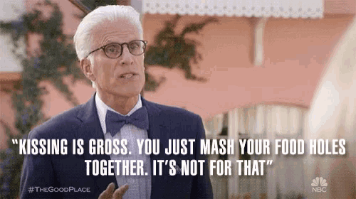 a man in a suit and bow tie is saying " kissing is gross you just mash your food holes together it 's not for that