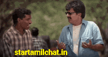 two men are having a conversation with a sign that says starttamilchat.in on it