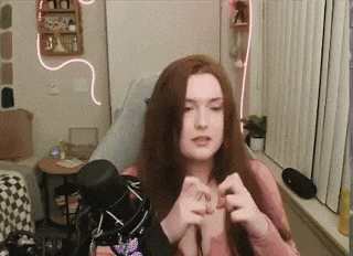 a woman is sitting in a chair in front of a microphone .