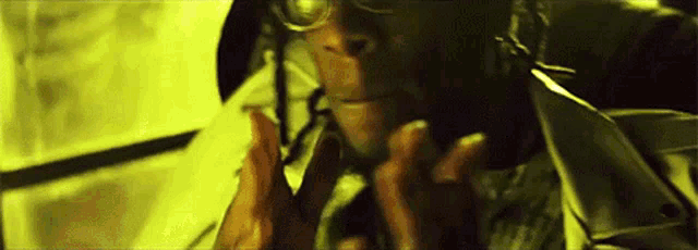 a close up of a man wearing glasses and a helmet .