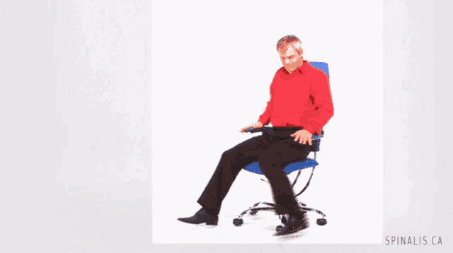 a man in a red shirt is sitting on a blue chair