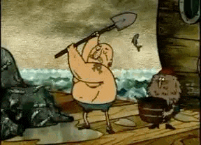 a man in a bathing suit is holding a shovel in his hand .
